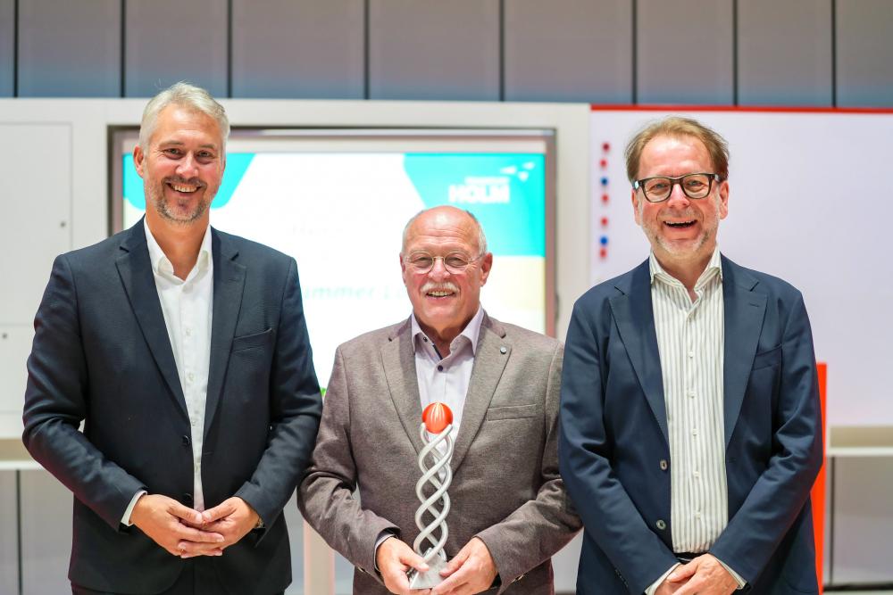 HOLM-Geschäftsführer Michael Kadow (links) und Stadtrat Wolfgang Siefert (rechts), Dezernent für Mobilität der Stadt Frankfurt/M., ehren Horst Amann mit dem HOLM-Leidenschaftspreis 2025.